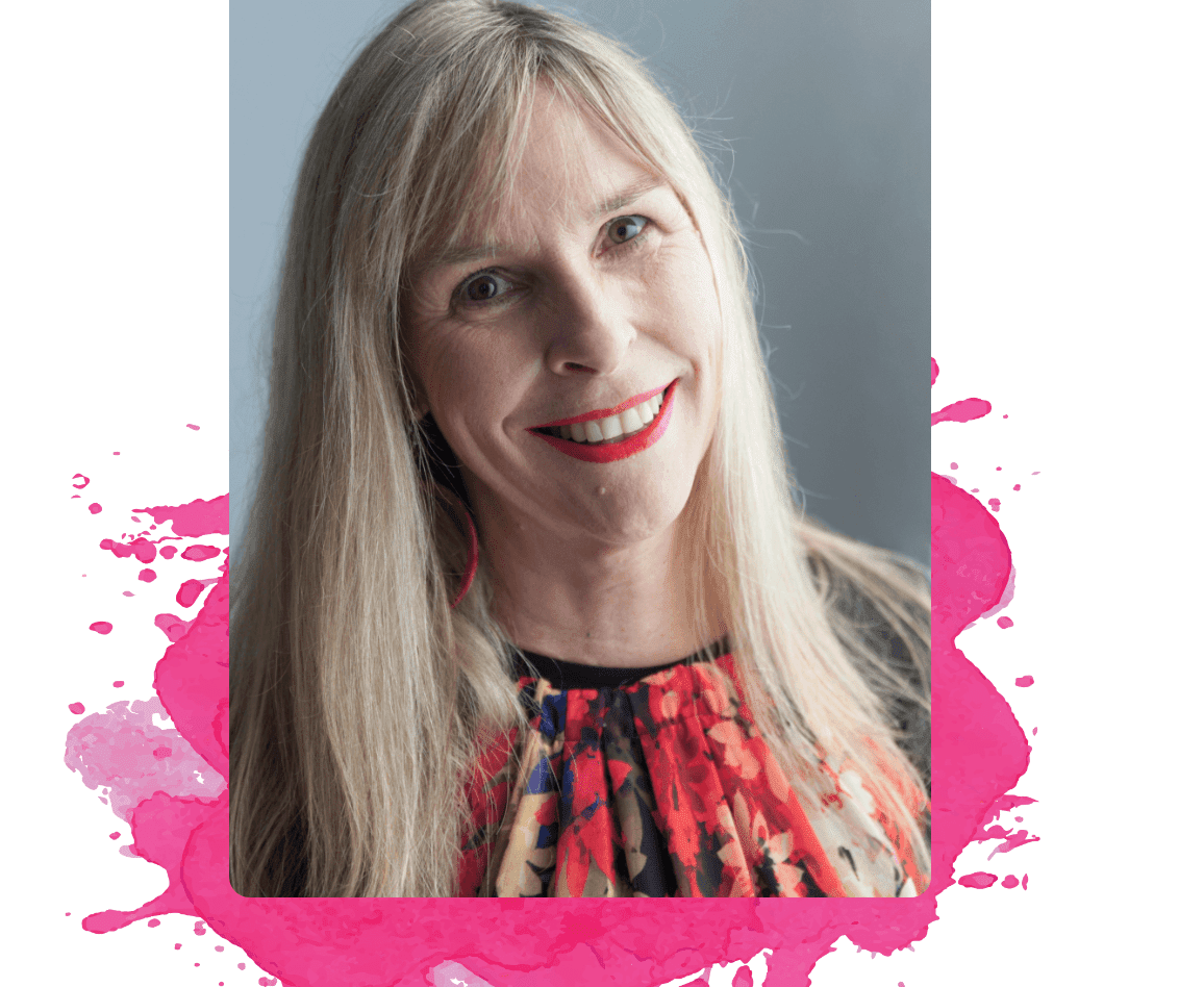 A blonde woman in a floral shirt smiles at the camera.